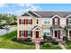 Charming townhome featuring colorful shutters, manicured landscaping and a brick-paved walkway at 696 Orange Belt Loop, Winter Garden, FL 34787