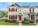 Charming two-story townhome featuring colorful shutters, brick accents, and well-maintained landscaping at 696 Orange Belt Loop, Winter Garden, FL 34787