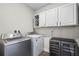 Modern laundry room featuring a wine refrigerator, washer, and dryer at 696 Orange Belt Loop, Winter Garden, FL 34787