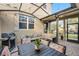 Relaxing covered patio with skylights features a built in fire pit, dining table, grill, and seating at 696 Orange Belt Loop, Winter Garden, FL 34787