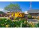 Historic yellow train car with surrounding greenery and flowers, offering a unique focal point at 696 Orange Belt Loop, Winter Garden, FL 34787