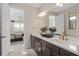 Stylish bathroom features a double sink vanity, bronze fixtures, and modern lighting at 7323 Sienna Wood Ave, Orlando, FL 32829