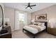 Bright bedroom with a large window, dresser, and neutral decor creates a peaceful ambiance at 7323 Sienna Wood Ave, Orlando, FL 32829