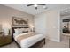 Bedroom with neutral paint, fan, and white closet doors presents a calm and relaxing space at 7323 Sienna Wood Ave, Orlando, FL 32829