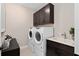 Well-equipped laundry room with modern washer/dryer, sink, and ample cabinet space at 7323 Sienna Wood Ave, Orlando, FL 32829