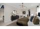 Well-lit main bedroom featuring a dresser with decorative gold accents and modern lighting fixture at 7323 Sienna Wood Ave, Orlando, FL 32829