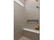 Modern tiled shower features a built-in bench, shower niche, and bronze fixtures at 7323 Sienna Wood Ave, Orlando, FL 32829