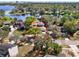 Aerial shot of a home with property lines, nestled among trees near a peaceful lake setting at 7496 Lake Marsha Dr, Orlando, FL 32819