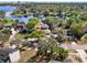 Aerial shot of a lakeside home surrounded by mature trees offering scenic waterfront views at 7496 Lake Marsha Dr, Orlando, FL 32819