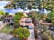 Aerial view of a home with an outline, showcasing its landscaping and proximity to a serene lake at 7496 Lake Marsha Dr, Orlando, FL 32819