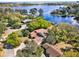 Stunning aerial view of lakeside home with lush landscaping and private dock at 7496 Lake Marsha Dr, Orlando, FL 32819