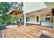 Spacious back deck with hot tub and stairs that lead to a second-story balcony and the home's interior at 7496 Lake Marsha Dr, Orlando, FL 32819