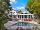 Large backyard with manicured lawn, a view of the in-ground pool, and the back of the house at 7496 Lake Marsha Dr, Orlando, FL 32819