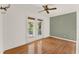 This bedroom features hardwood floors and a set of french doors to a patio at 7496 Lake Marsha Dr, Orlando, FL 32819