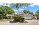 Charming home featuring a circular paver driveway and a lush, well-maintained front yard at 7496 Lake Marsha Dr, Orlando, FL 32819