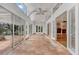 Hallway with tile floors, high ceilings, and many windows that let in a lot of natural light at 7496 Lake Marsha Dr, Orlando, FL 32819