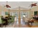 Spacious living room featuring hardwood floors, ceiling fans, and access to a screened patio at 7496 Lake Marsha Dr, Orlando, FL 32819