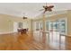 Spacious living room featuring hardwood floors, ceiling fans, and access to a screened patio at 7496 Lake Marsha Dr, Orlando, FL 32819