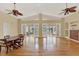 Spacious living room featuring hardwood floors, ceiling fans, and access to a screened patio at 7496 Lake Marsha Dr, Orlando, FL 32819