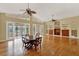 Spacious living room featuring hardwood floors, ceiling fans, and access to a screened patio at 7496 Lake Marsha Dr, Orlando, FL 32819