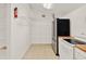 Bright pantry with white appliances, wood countertops, shelving and a fire extinguisher at 7496 Lake Marsha Dr, Orlando, FL 32819