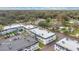 Apartment complex featuring multiple buildings with gray roofs, surrounded by lush trees and greenery at 7636 Forest City Rd # F/70, Orlando, FL 32810