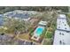 Aerial view of community featuring pool, tennis court, lush landscaping and ample parking at 7636 Forest City Rd # F/70, Orlando, FL 32810