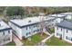 Aerial view of a multi-Gathering building featuring black shutters and a tree with hanging moss at 7636 Forest City Rd # F/70, Orlando, FL 32810