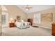 Well-lit bedroom featuring a vaulted ceiling, plantation shutters, and neutral decor at 7655 Debeaubien Dr, Orlando, FL 32835