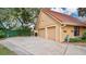 Exterior shot of a two car garage with a wide driveway at 7655 Debeaubien Dr, Orlando, FL 32835