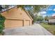 Home featuring a spacious two car garage and driveway at 7655 Debeaubien Dr, Orlando, FL 32835