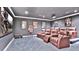 Home theater with plush seating, a large screen, and movie memorabilia at 7655 Debeaubien Dr, Orlando, FL 32835