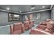 Comfortable home theater seating with a large screen for the ultimate viewing experience at 7655 Debeaubien Dr, Orlando, FL 32835