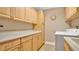 Bright laundry room features ample storage and a modern washer and dryer at 7655 Debeaubien Dr, Orlando, FL 32835