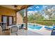 View of patio with seating area overlooking beautiful in-ground pool at 7655 Debeaubien Dr, Orlando, FL 32835