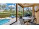 View of patio seating next to pool with screened in porch at 7655 Debeaubien Dr, Orlando, FL 32835