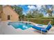 Enjoy the Florida sunshine with a private in-ground pool and lounge chairs at 7655 Debeaubien Dr, Orlando, FL 32835