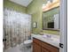 Bathroom with neutral color scheme, tile floor, and a shower with floral curtain at 814 Kazaros Cir, Ocoee, FL 34761