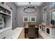 Formal dining area with a decorative chandelier, white wainscoting, and large windows at 814 Kazaros Cir, Ocoee, FL 34761