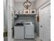 Convenient laundry room with a modern washer and dryer, plus storage shelves for supplies at 814 Kazaros Cir, Ocoee, FL 34761