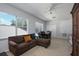 Comfortable living room features abundant natural light, a ceiling fan, and a cozy brown sofa at 814 Kazaros Cir, Ocoee, FL 34761