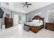 Primary bedroom with a door to a private lanai featuring a tray ceiling and wood furniture at 814 Kazaros Cir, Ocoee, FL 34761