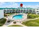 An elevated shot reveals a pool surrounded by manicured lawns and a secure fence, situated near condominium buildings at 815 Ocean Shore Blvd # U7A, Ormond Beach, FL 32176