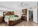 This bedroom features natural light, wooden furniture, and a bed with a tropical leaf patterned comforter at 815 Ocean Shore Blvd # U7A, Ormond Beach, FL 32176