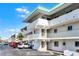 Exterior shot of a condo building with parking spaces and landscaping in front at 815 Ocean Shore Blvd # U7A, Ormond Beach, FL 32176