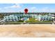 Exterior shot revealing the condo complex positioned adjacent to a sandy beach, framed by bright blue skies at 815 Ocean Shore Blvd # U7A, Ormond Beach, FL 32176