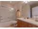 Well-lit bathroom with a shower-tub combo and vanity with wooden cabinets at 8168 Boat Hook Loop # 707, Windermere, FL 34786