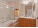 Well-lit bathroom with a shower-tub combo and vanity with wooden cabinets at 8168 Boat Hook Loop # 707, Windermere, FL 34786