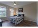 Bedroom featuring wood floors, a ceiling fan, natural light, and black and white floral bedding at 8168 Boat Hook Loop # 707, Windermere, FL 34786