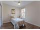 Cozy bedroom with wood floors, bright window, and a ceiling fan for added comfort at 8168 Boat Hook Loop # 707, Windermere, FL 34786